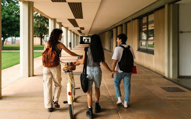 a group of people walking down a sidewalk