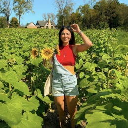 a young woman smiling in a field