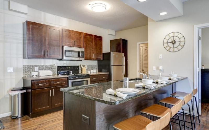 a kitchen with a marble bar stools