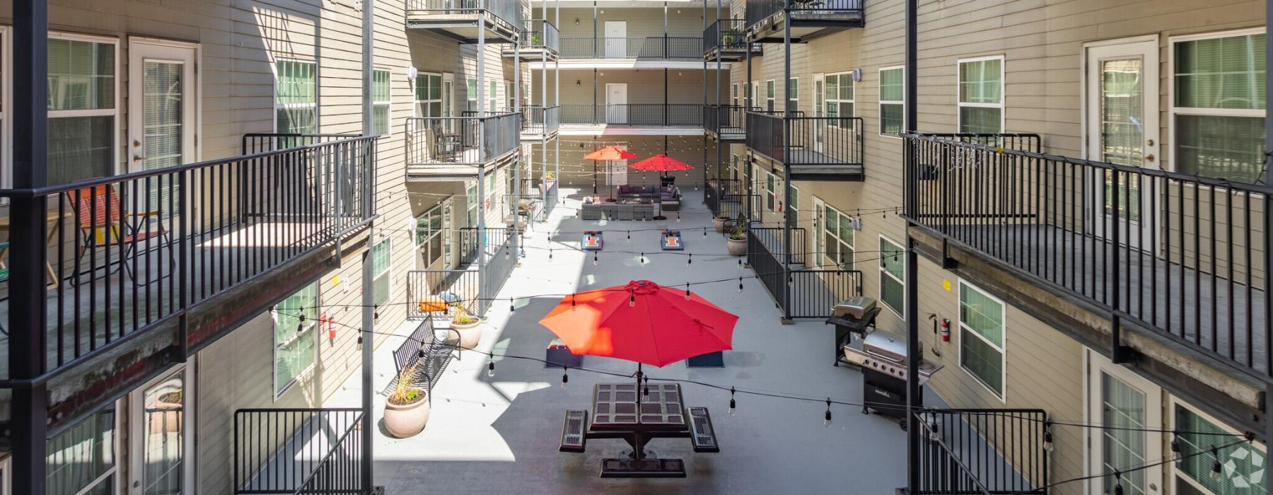 a street with buildings and umbrellas