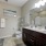 bathroom with double vanity and large mirror