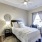 a bedroom with a nightstand and a lamp