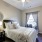 a bedroom with nightstand and lamp