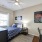 bedroom with a desk, dresser, and nightstand
