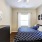 bedroom with art on the walls and a large window